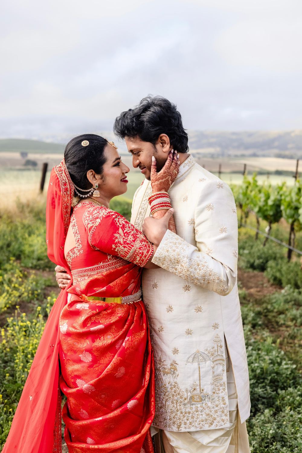 A quiet moment in the vines, her henna hand resting on his cheek